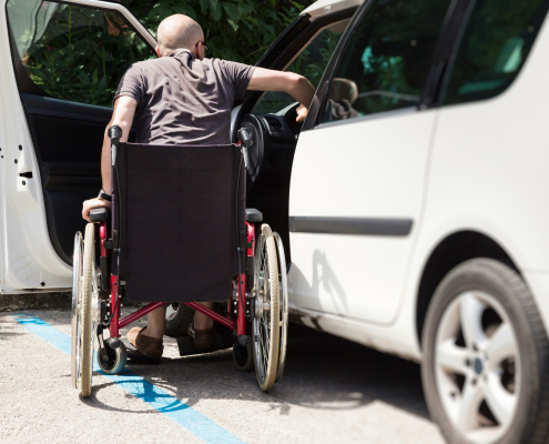 iStock 000056426418 male wheelchair entering car sm scaled